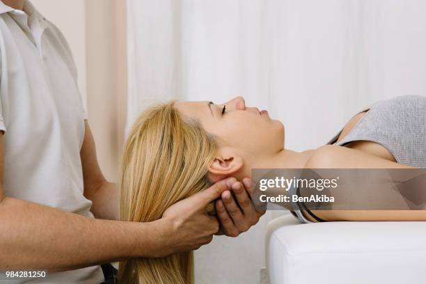 chiropractic neck adjustment - osteopath stock pictures, royalty-free photos & images