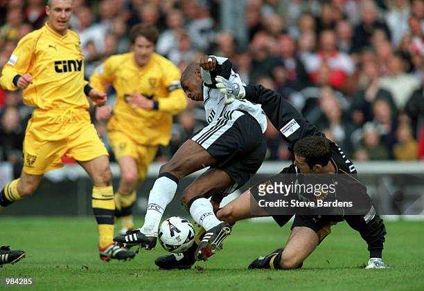 Luis Boa Morte of Fulham is tackled by Wimbledon keeper Kelvin Davis during the Nationwide Division One match between Fulham and Wimbledon at Craven...