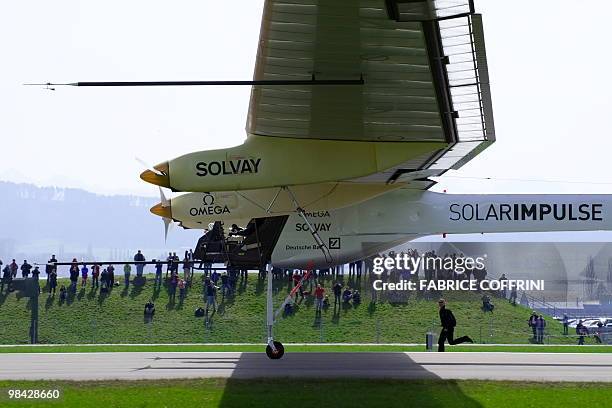 The Solar Impulse aircraft, a pioneering Swiss bid to fly around the world on solar energy lands after it first test flight on april 7, 2010 from...