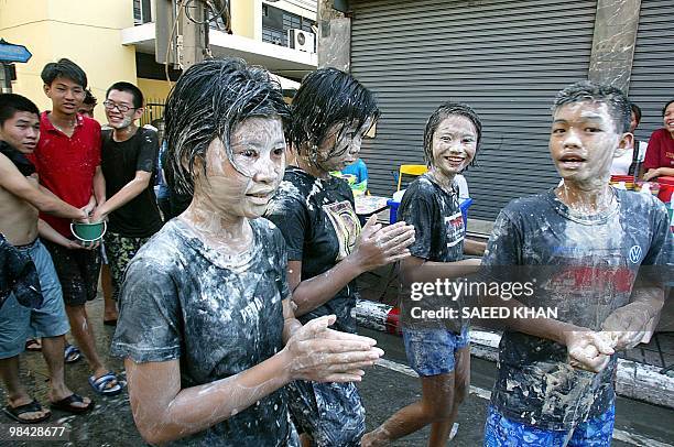 Children with powder on their faces enjoying the Songkran Festival, also know as the water festival in Bangkok, 13 April 2004. The three-day Songkran...