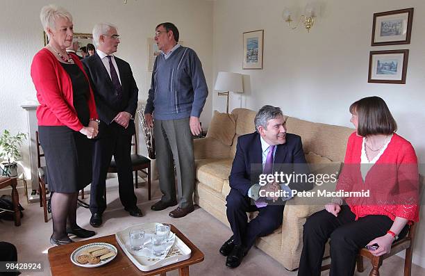 Prime Minister Gordon Brown talks to Katheryne McKinley as Chancellor Alistair Darling talks to house owner Les White as Labour party candidate for...