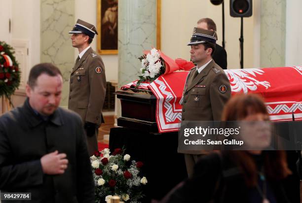 Mourners walk in silence by the coffins of late Polish President Lech Kaczynski and his wife Maria that were lying in state at the Presidential...