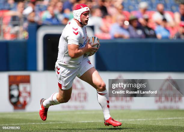 Chris Hill of England runs the ball back during the second half of a Rugby League Test Match between England and the New Zealand Kiwis at Sports...