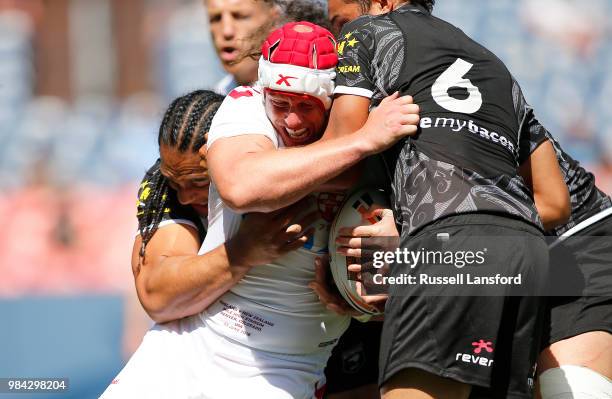 Martin Taupau and Te Maire Martin of New Zealand tackle Chris Hill of England during the second half of a Rugby League Test Match between England and...