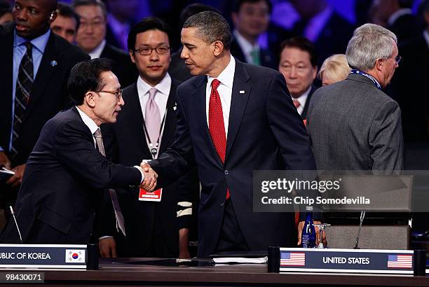 South Korean President Lee Myung-bak shakes hands with U.S. President Barack Obama while joining world political leaders for the opening plenary...