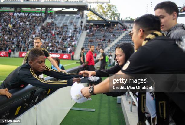 Forward Latif Blessing of the LAFC signs autographs for fans at the Los Angeles FC MLS game against Columbus Crew at Banc of California Stadium on...