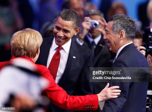 President Barack Obama talks with German Chancellor Angela Merkel and Prime Minister of Singapore Lee Hsien Loong while joining other world political...