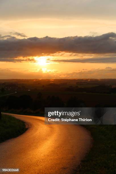 sunset on the road / coucher de soleil sur la route - coucher soleil stock pictures, royalty-free photos & images