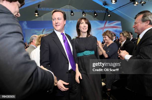 Conservative party leader David Cameron is congratulated by supporters as he leaves Battersea Power Station with his wife Samantha after launching...