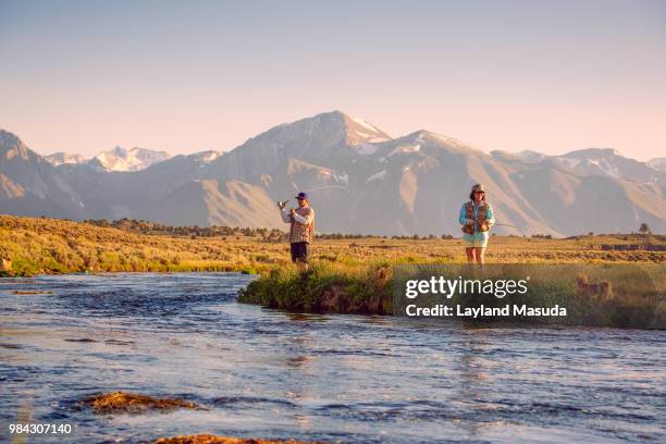 fishing in the eastern sierra - man, woman, dog - meadow brook imagens e fotografias de stock