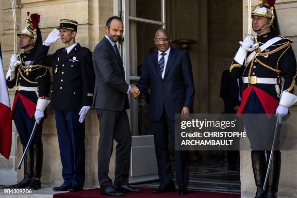 French Prime Minister Edouard Philippe shakes hands with Malian Prime Minister Soumeylou Boubèye Maïga at the Hotel Matignon in Paris on June 26,...