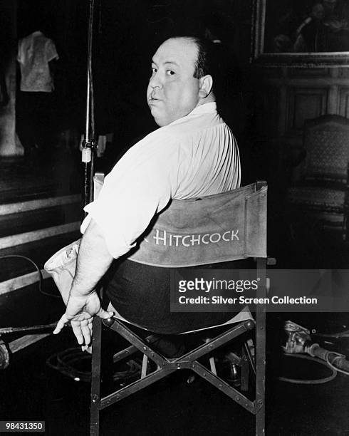 English film director Alfred Hitchcock poses on a film set, circa 1940.