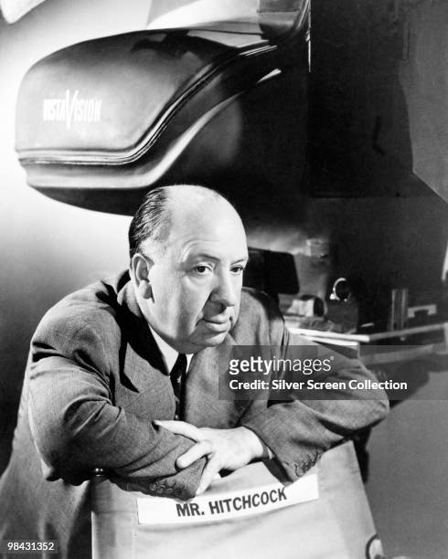 English film director Alfred Hitchcock with a VistaVision camera in a 'blimp' or soundproof casing, circa 1954. Hitchcock used VistaVision between...