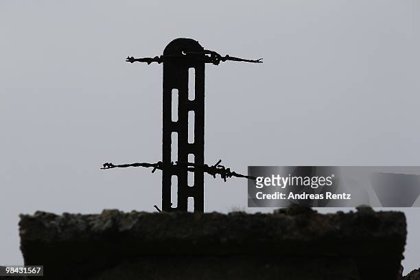 Parts of barbed wire fence at the entrance tower of the former concentration camp Sachsenhausen are pictured on April 13, 2010 in Oranienburg,...