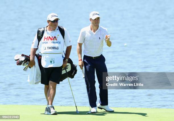 Justin Thomas of the USA throws back the ball of his pro-am amateur playing partner after catching and stopping the ball flying through the air and...