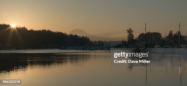 sun peaking over gig harbor - gig harbor stock pictures, royalty-free photos & images