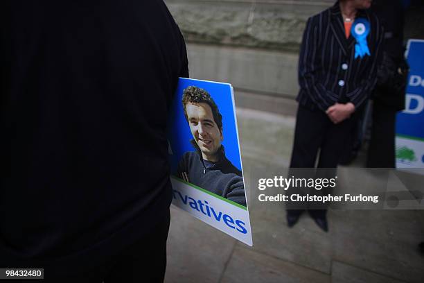 Conservative party supporter holds a placard with the picture of Edward Timpson MP, as he waits for Shadow Foreign Secretary William Hague to launch...