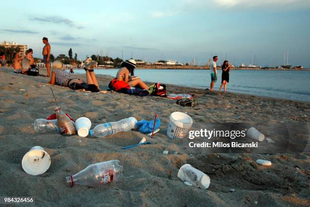 Plastic cups and bottles used by tourists on the Aegean sea beach near Athens on June 26 Greece . The Mediterranean is one of the seas with the...