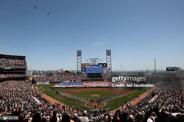 Players and coaches line up for the National Anthem before the San Francisco Giants and the Atlanta Braves Opening Day game at AT&T Park on April 9,...