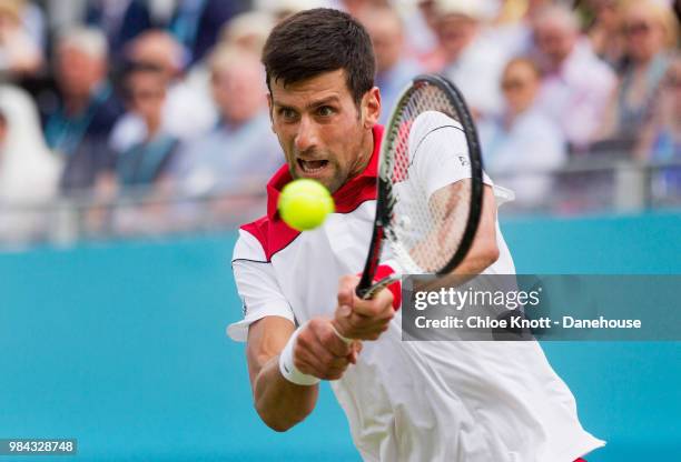 Novak Djokovic of Serbia plays a backhand shot against John Millman of Australia on day two of the Fever-Tree Championships at Queens Club on June...