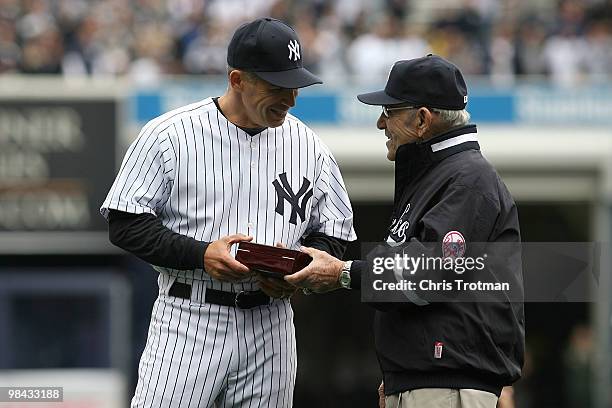 Yankee legend and Baseball Hall of Famer Yogi Berra presents manager Joe Girardi of the New York Yankees with his World Series ring for the 2009...