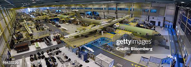 This photo, which is made from 13 images stitched together in Photoshop, shows Bombardier Q400 NextGen turboprop airliners under construction, in one...