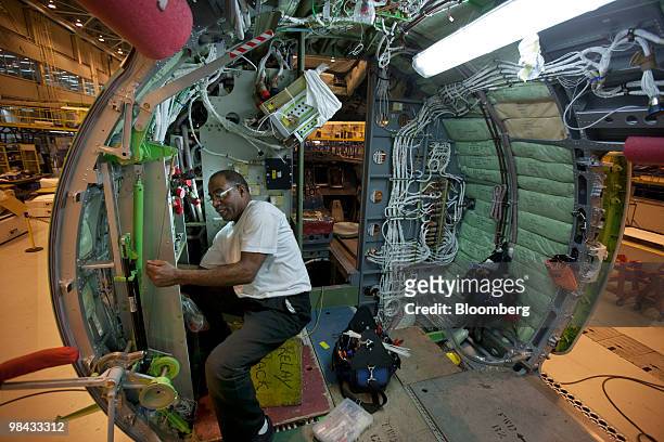 Wennel Best works inside the fuselage of a Bombardier Q400 NextGen turboprop airliner, in one of the hangars at the Bombardier Aerospace plant at...