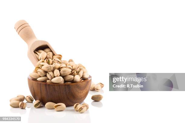 pistachio nut close up on white background isolated - crack spoon stock pictures, royalty-free photos & images