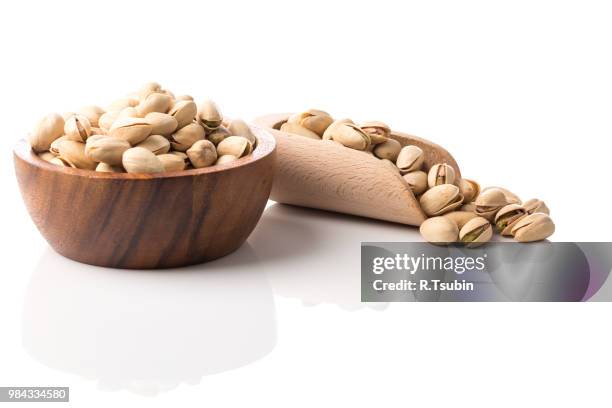 pistachio nut close up on white background isolated - crack spoon stock pictures, royalty-free photos & images