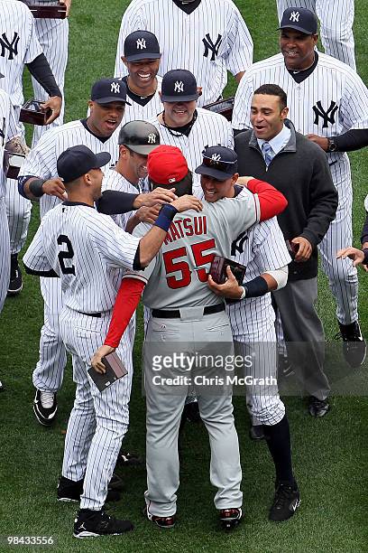 Hideki Matsui of the Los Angeles Angels of Anaheim is greeted by former teammates Alex Rodriguez, Derek Jeter, Jorge Posada, Robinson Cano, Joba...