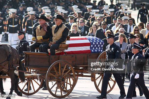 The casket carrying the remains of 45-year-old Los Angeles police SWAT officer and Marine reservist Robert J. Cottle is carried in a mule-drawn...