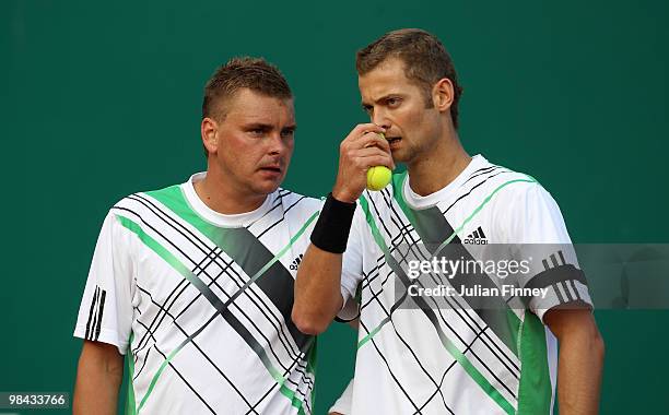 Marcin Matkowski and Mariusz Fyrstenberg of Poland talk tactics in their match against Mahesh Bhupathi of India and Max Mirnyi of Belarus during day...