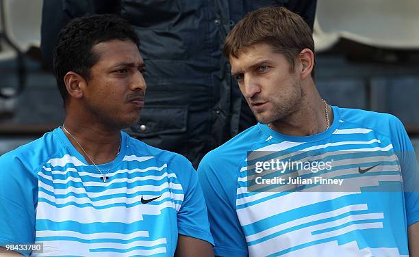 Mahesh Bhupathi of India and Max Mirnyi of Belarus talk tactics in their match against Marcin Matkowski and Mariusz Fyrstenberg of Poland during day...