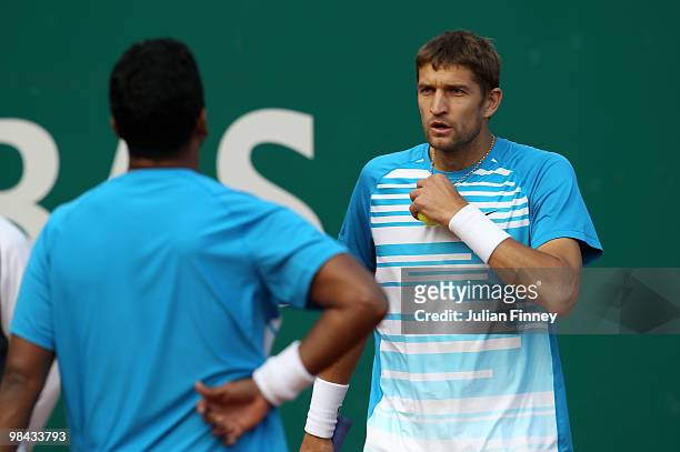 Mahesh Bhupathi of India and Max Mirnyi of Belarus talk tactics in their match against Marcin Matkowski and Mariusz Fyrstenberg of Poland during day...