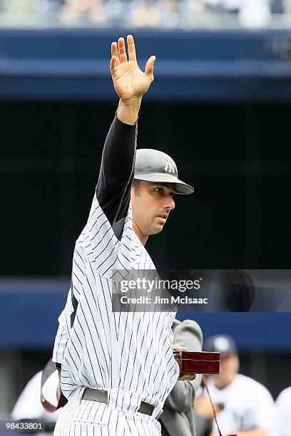 Jorge Posada of the New York Yankees acknowledges the fans after he received his 2009 World Series ring prior to playing against the Los Angeles...