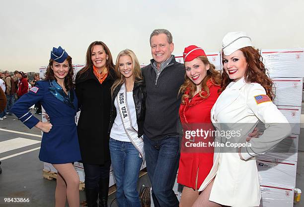 Heather Hart, Miss USA Kristen Dalton, and Texas Roadhouse CEO G. J. Hart pose for pictures with USO Girls before packing goody bags for overseas...