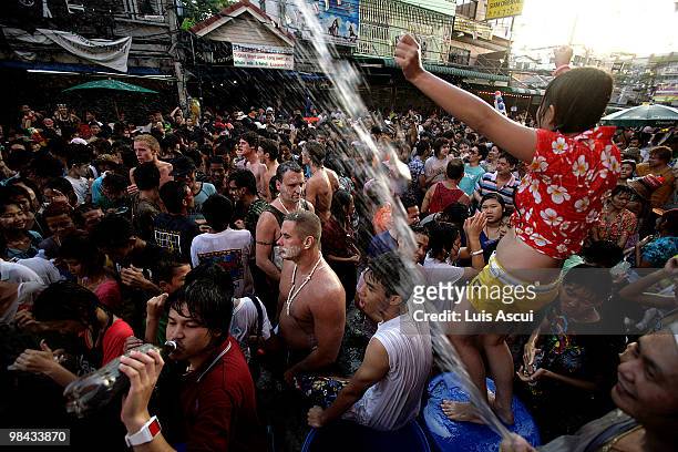 Tourists and Thai people celebrate on the first of three days of Songkran New Year festival, amid the political turmoil of weeks of protests and more...