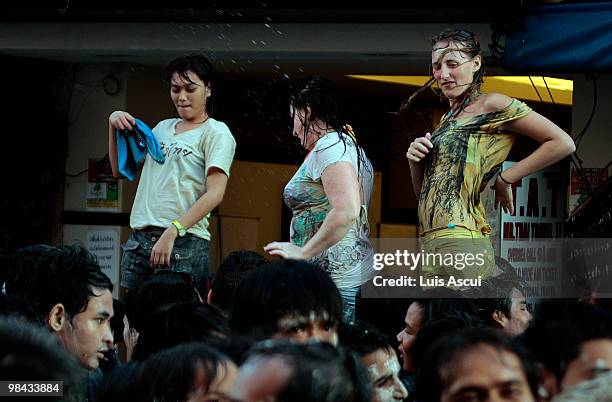 Tourists and Thai people celebrate on the first of three days of Songkran New Year festival, amid the political turmoil of weeks of protests and more...