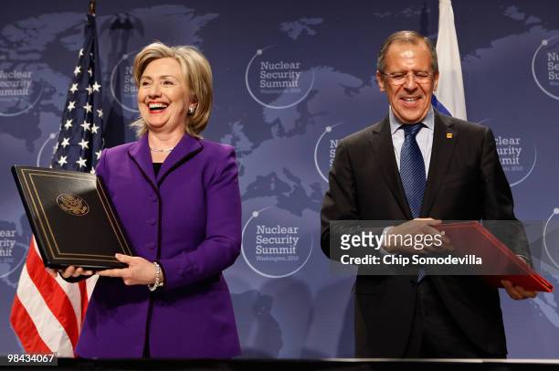 Secretary of State Hillary Rodham Clinton and Russian Foreign Minister Sergey Lavrov smile after signing an agreement on eliminating excess...