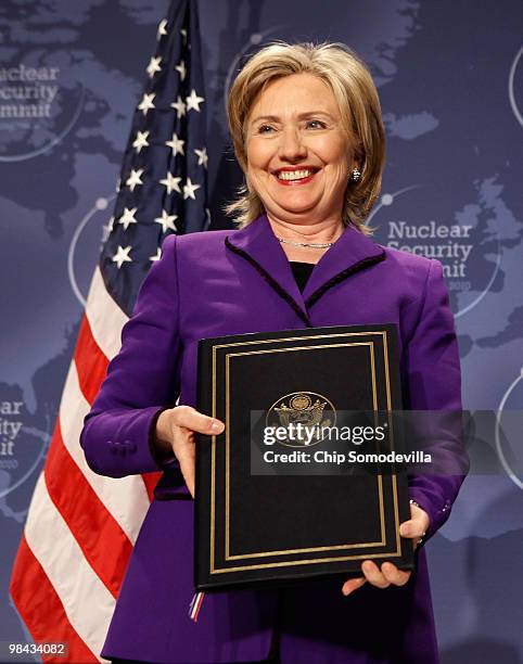 Secretary of State Hillary Rodham Clinton holds her copy of an agreement on eliminating excess weapon-grade plutonium from her country's and the...