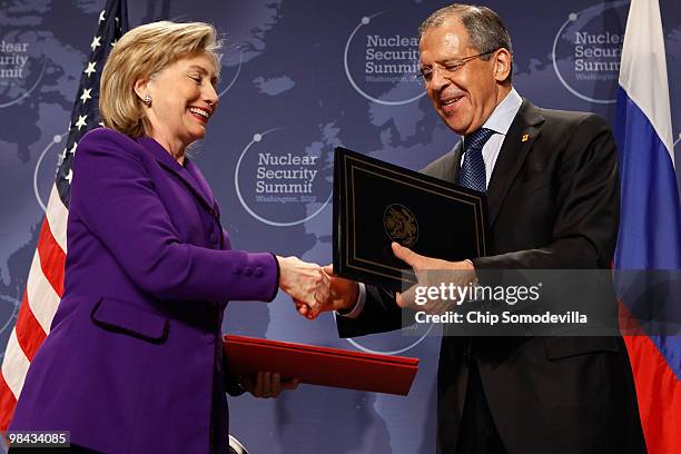 Secretary of State Hillary Rodham Clinton and Russian Foreign Minister Sergey Lavrov exchange signed copies of an agreement on eliminating excess...