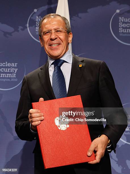 Russian Foreign Minister Sergey Lavrov holds his copy of an agreement on eliminating excess weapon-grade plutonium from his country's and the United...