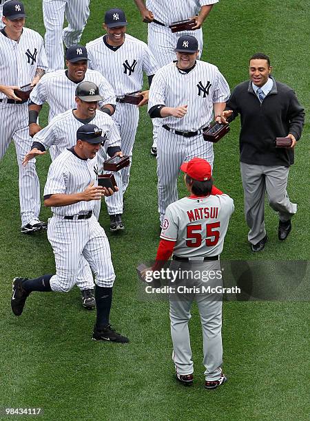 Hideki Matsui of the Los Angeles Angels of Anaheim is greeted by former teammates Alex Rodriguez, Derek Jeter, Jorge Posada, Robinson Cano, Joba...