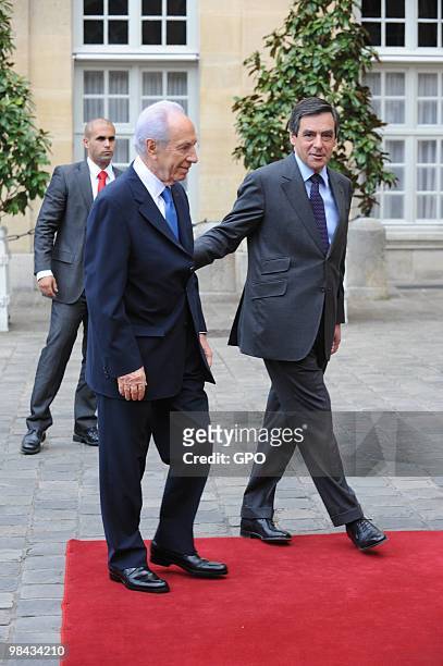 In this handout image from the Israeli Government Press Office, President Shimon Peres walks with French Prime Minister Francois Fillon on April 13,...