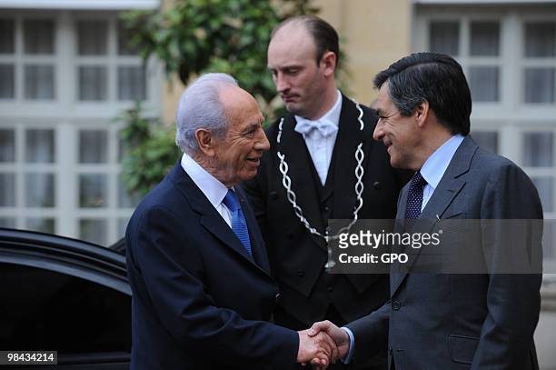 In this handout image from the Israeli Government Press Office, President Shimon Peres shakes hands with French Prime Minister Francois Fillon on...