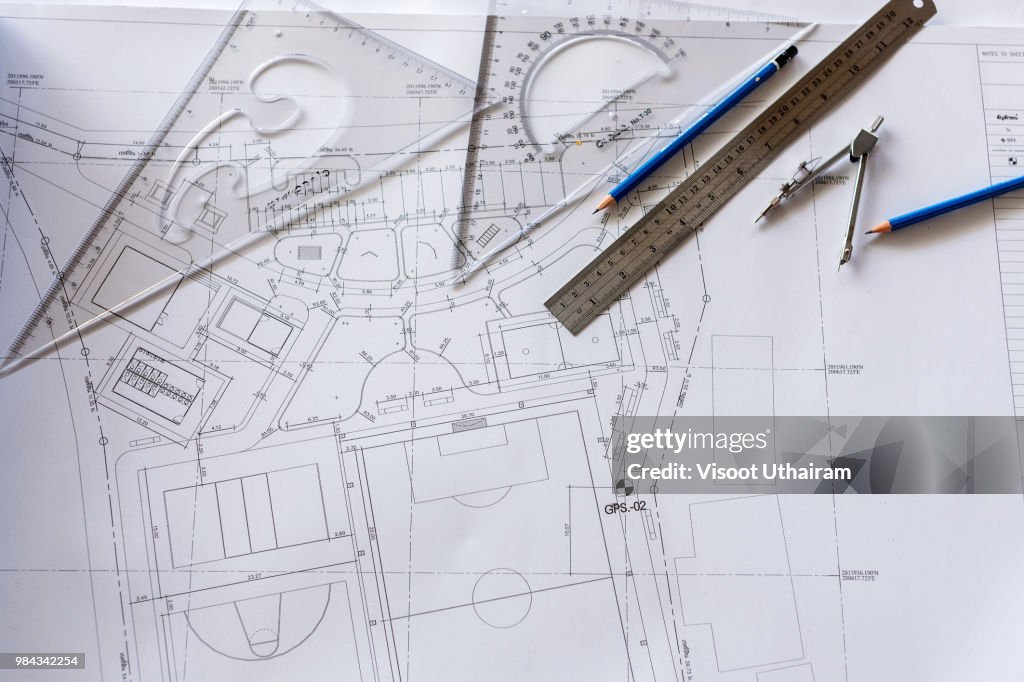 Close-up of Architect engineer drawing plan on blueprint with architect equipment