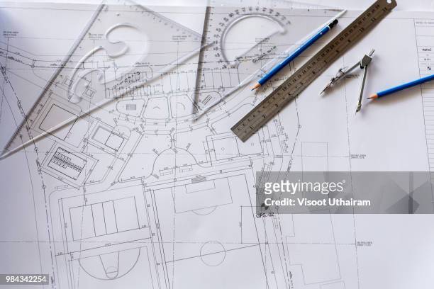close-up of architect engineer drawing plan on blueprint with architect equipment - planning design ストックフォトと画像