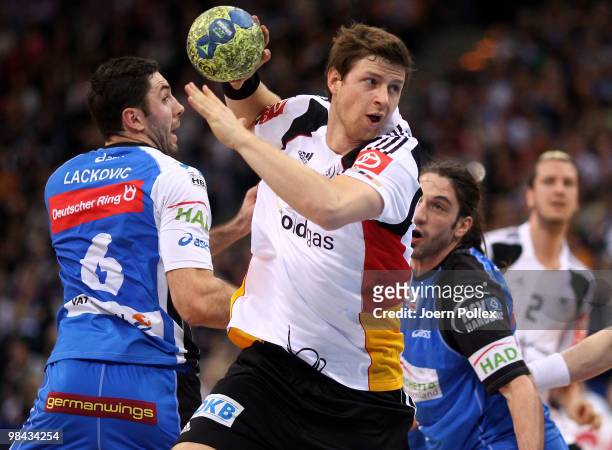 Blazenko Lackovic and Bertrand Gille of Hamburg and Martin Strobel of Germany compete for the ball during the charity match for benefit of Oleg...