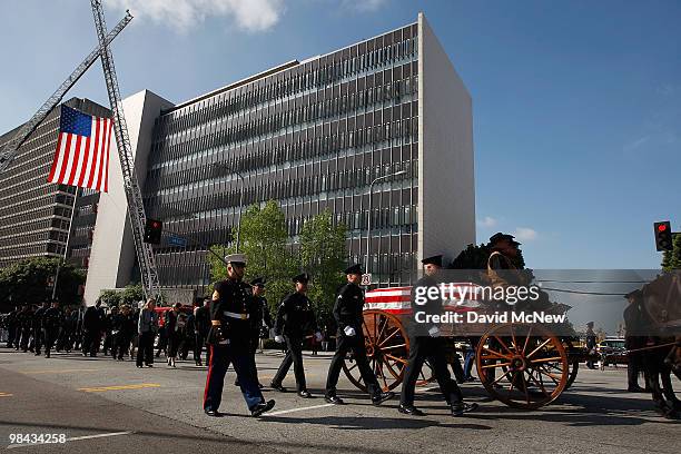 The casket carrying the remains of 45-year-old Los Angeles police SWAT officer and Marine reservist Robert J. Cottle is carried in a mule-drawn...