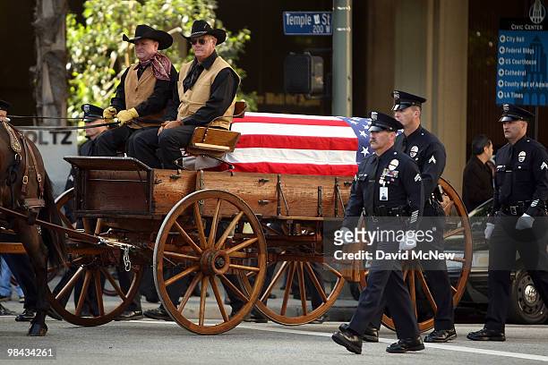 The casket carrying the remains of 45-year-old Los Angeles police SWAT officer and Marine reservist Robert J. Cottle is carried in a mule-drawn...